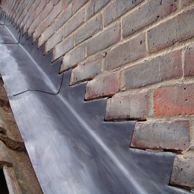Lead flashing to a brick wall