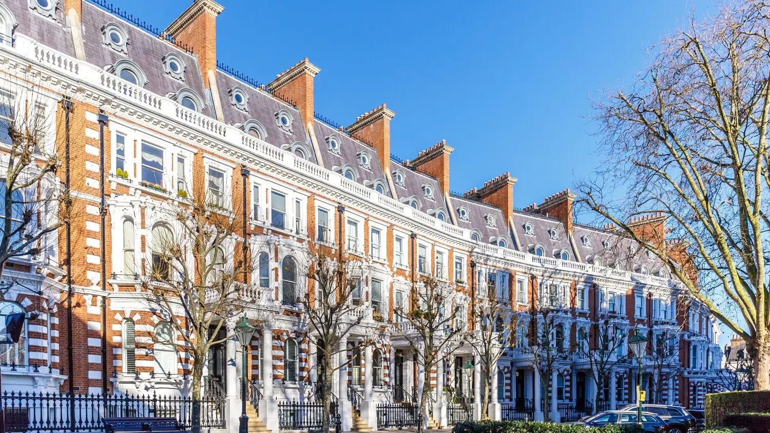 A row of red brick and stucco terraced houses in west London