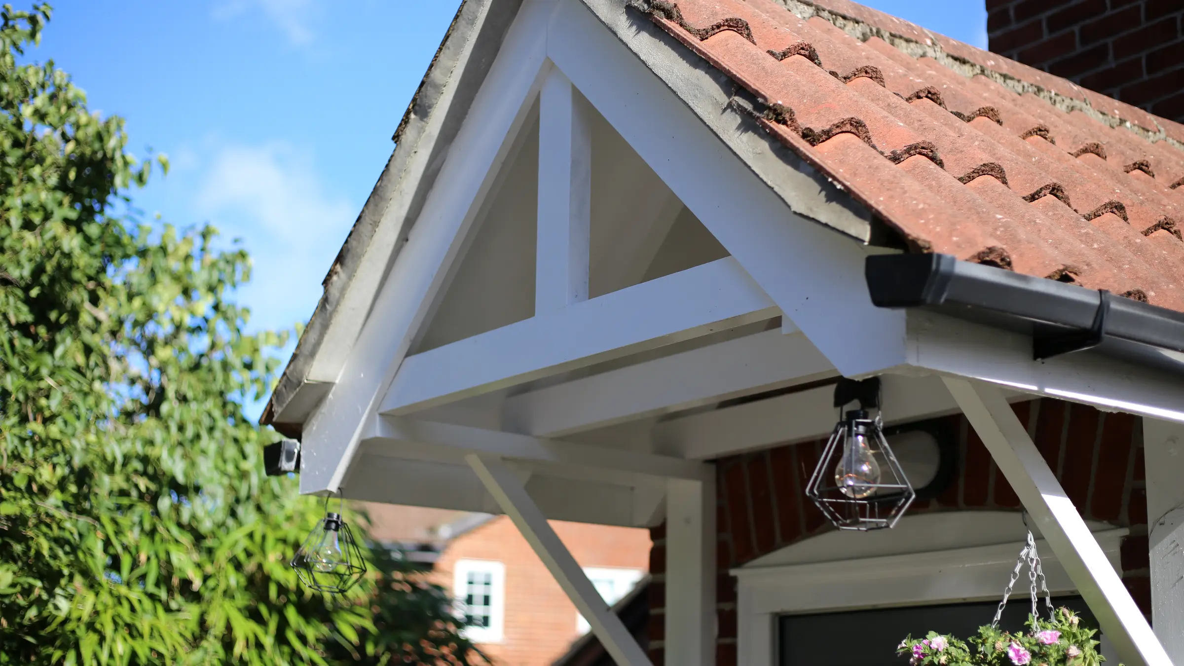 A tiled porch canopy and roofline on a brick house