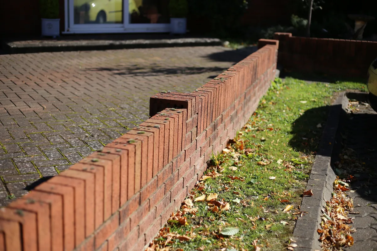 New brickwork on a garden wall with a soldier course