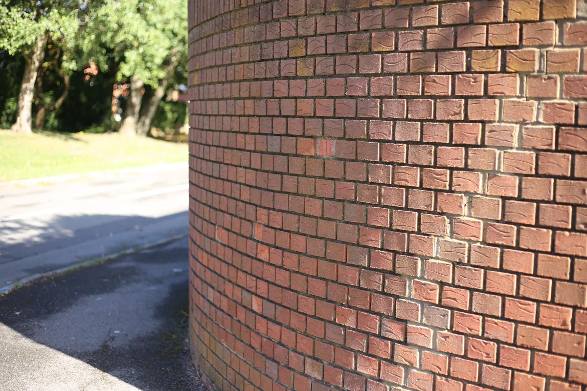 A brick boundary wall built with a rounded return