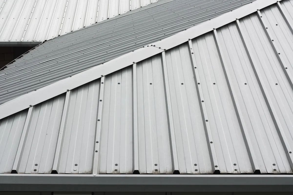 A profiled metal roof run finished along the ridge