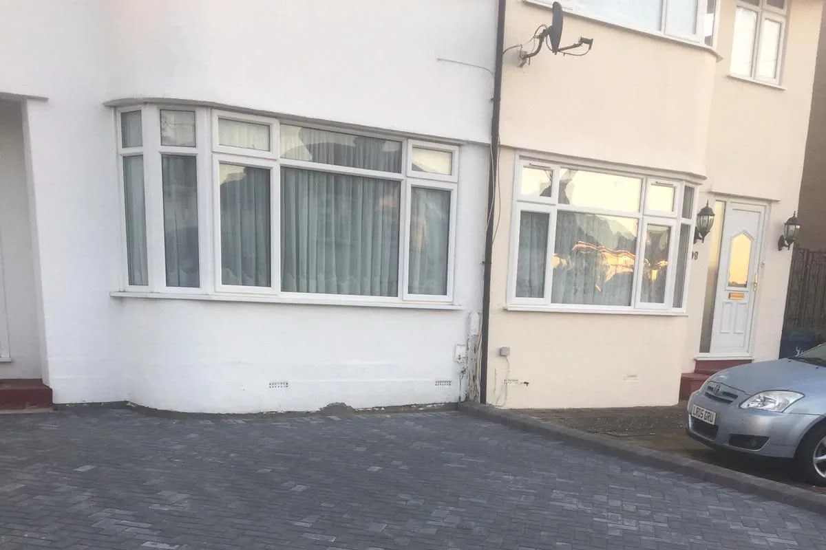 A block paved drive and path in front of a white rendered semi