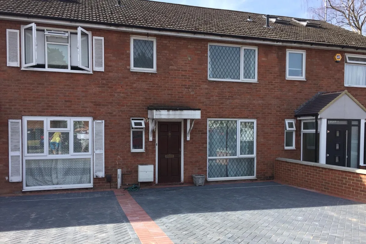 Block paving with a red brick border laid across a front garden