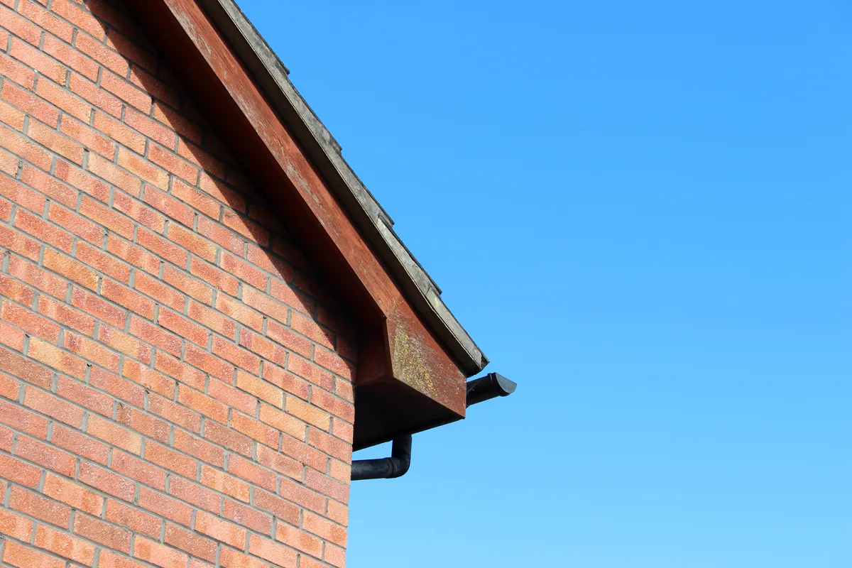 A capped fascia and soffit along a brick gable