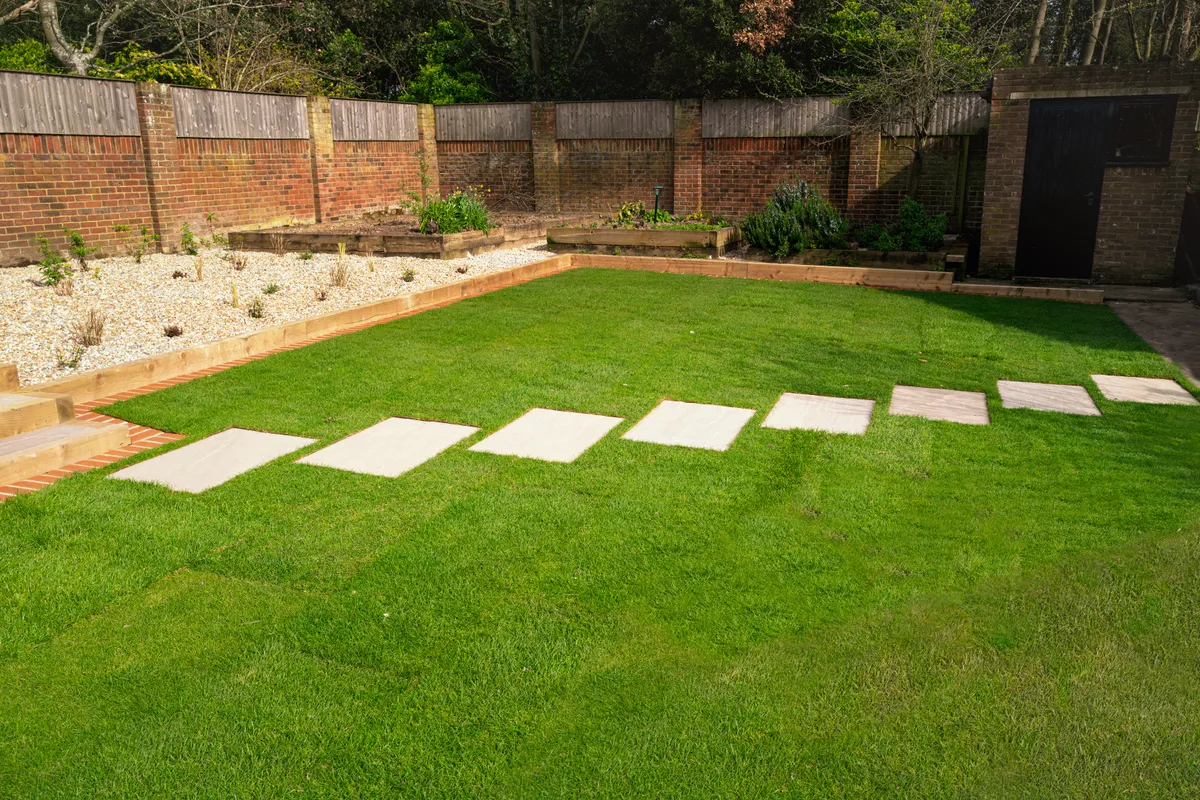 Paving slabs laid as a path across a rear lawn