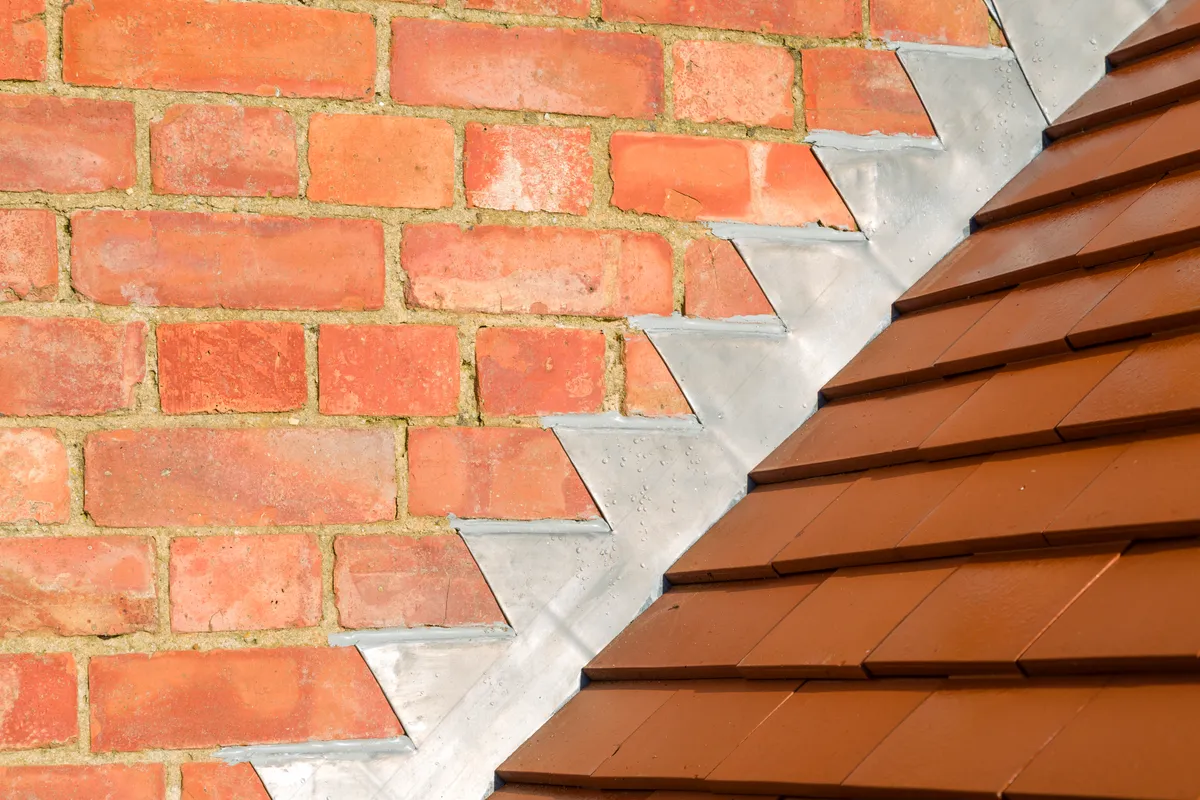 Lead soakers and a stepped flashing dressed into brickwork