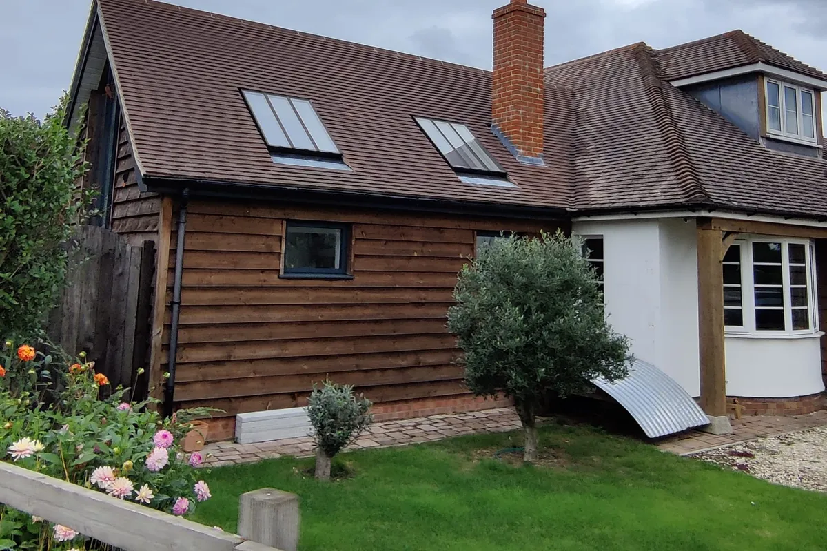 A new tiled roof with rooflights and a brick chimney