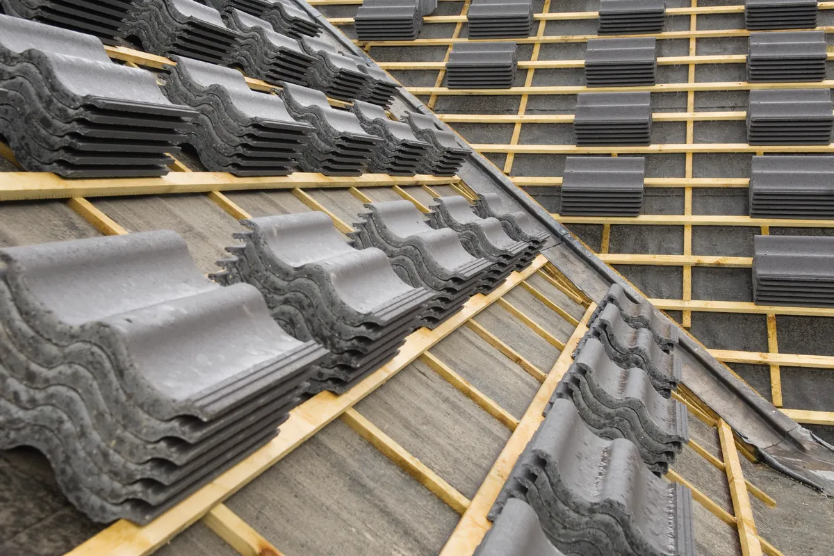Concrete tiles set out on new battens over a fresh underlay