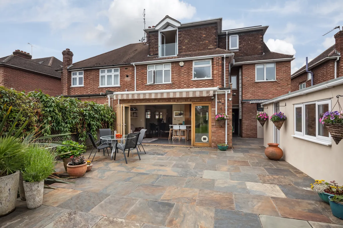 A finished sandstone patio behind a West London house