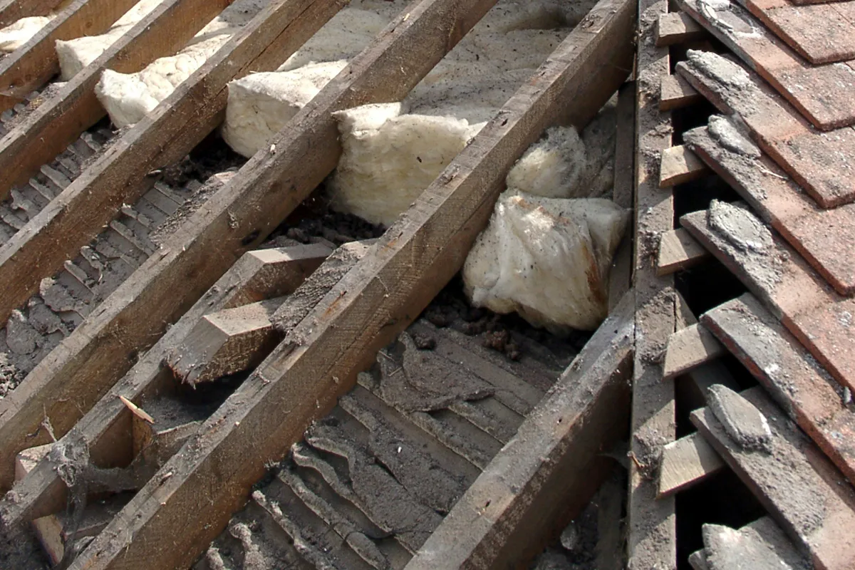 Battens and broken tile exposed where a roof has failed