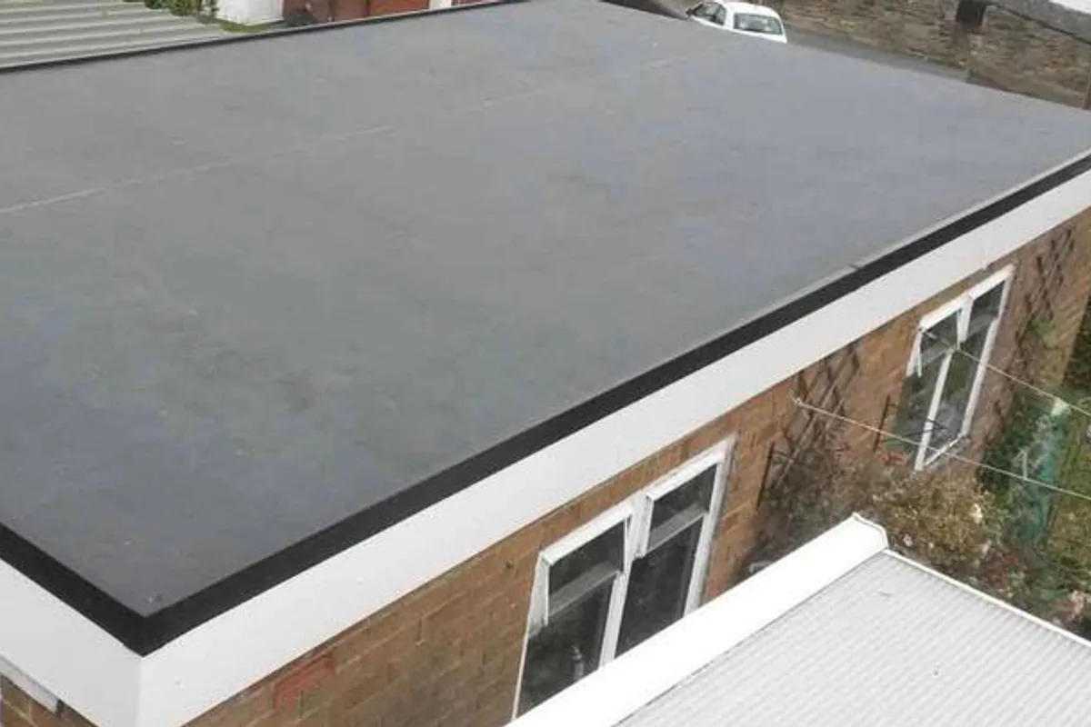 A finished rubber flat roof over a rear extension with a white fascia