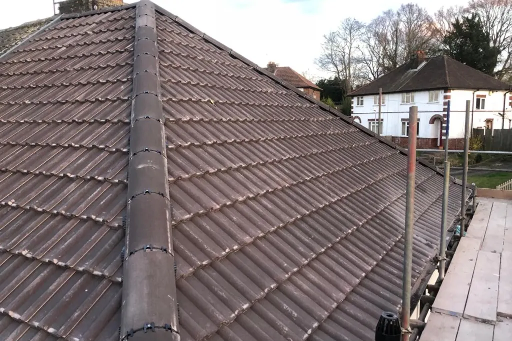 A finished terracotta tiled roof with a dry fixed ridge line